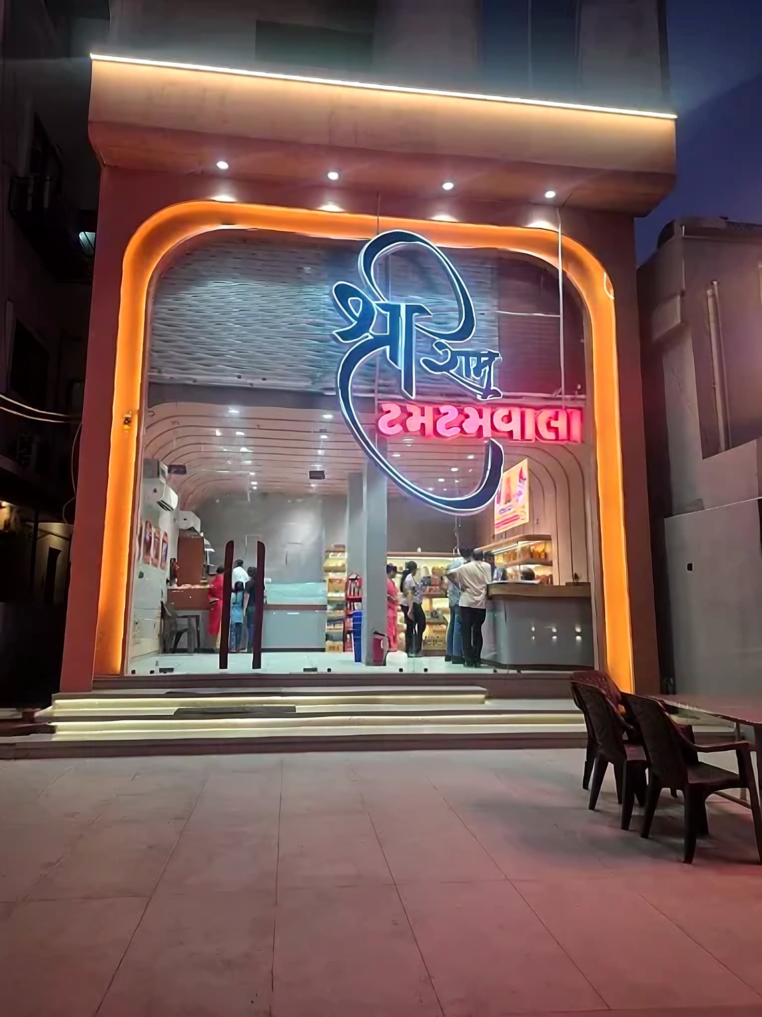 Shriram Tamtam Wala storefront, lit up at night on Waghodia Road